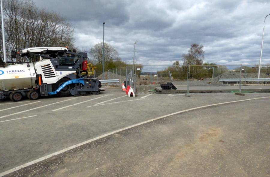 Street utility work area with barriers before restoration